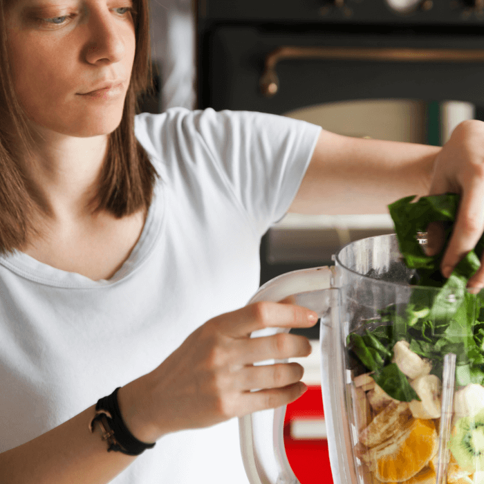 woman making a hormone health smoothie